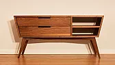 Walnut Credenza with Tapered Legs and Angled Sides |  Unlike many traditional credenzas that maintain a simple rectangular profile,...