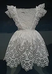 Broderie Anglaise (sp)? |  Like this:http://en.wikipedia.org/wiki/Broderie_Anglaise ?That looks like what...